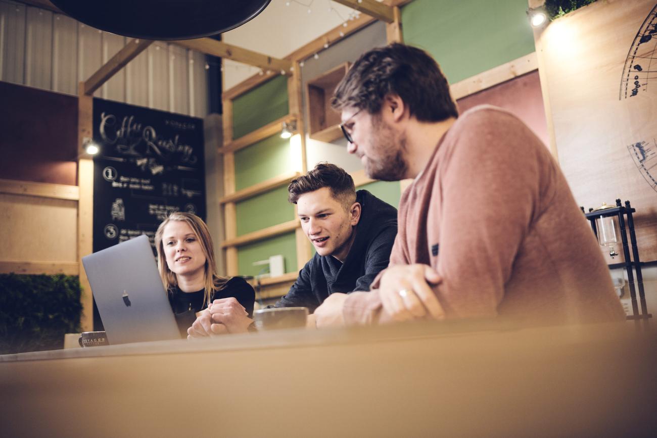 studio illicit team looking at a laptop