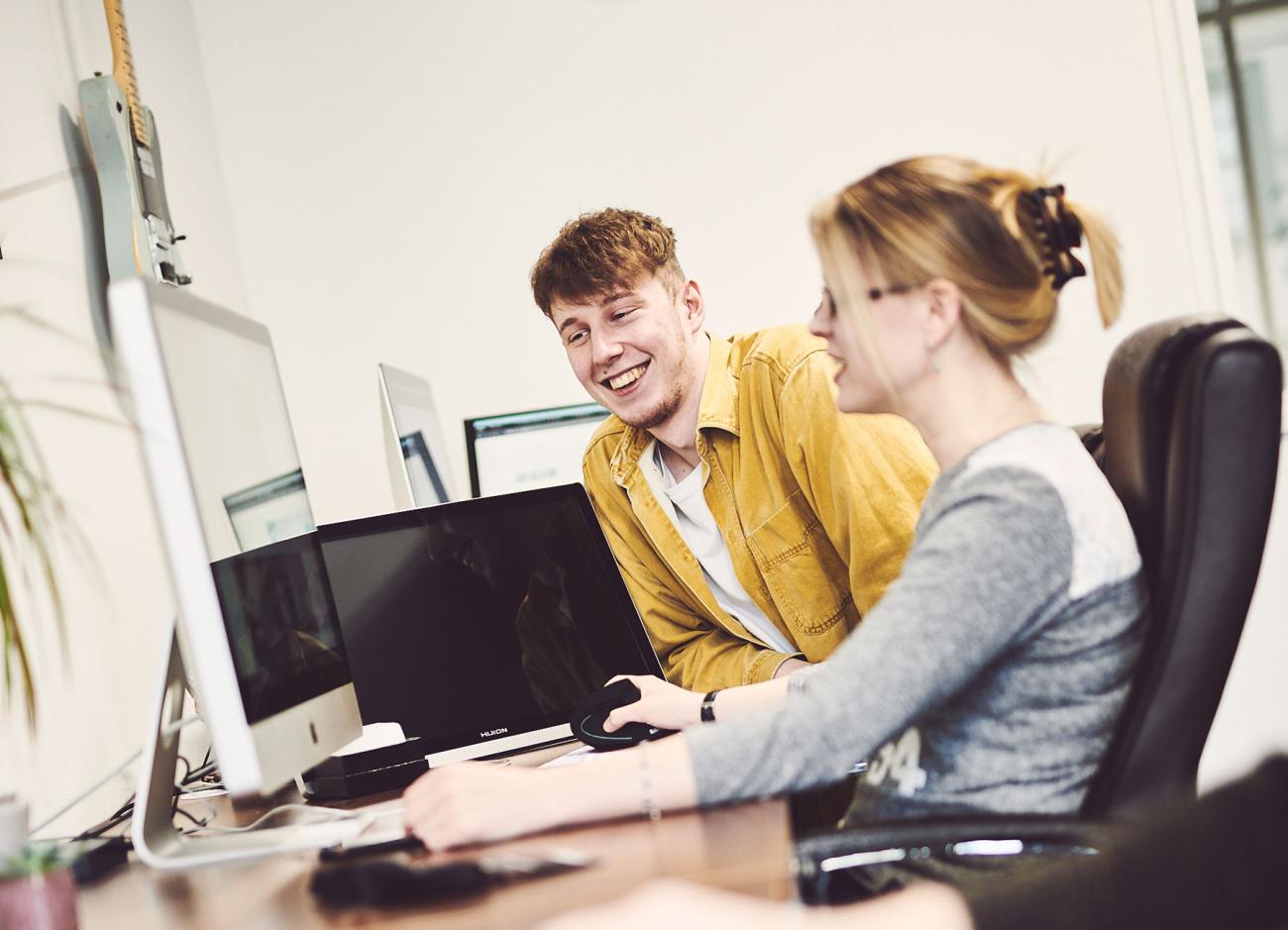 colleagues working behind a computer screen