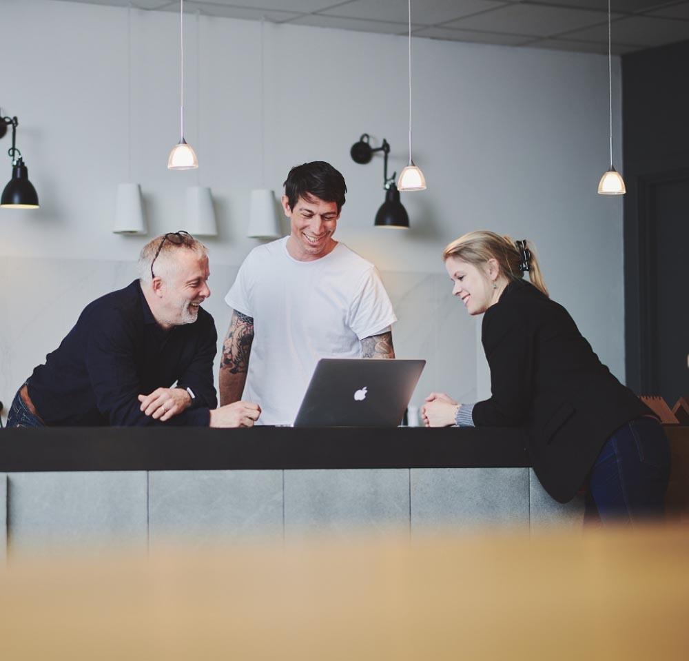 studio illicit team looking at laptop screen